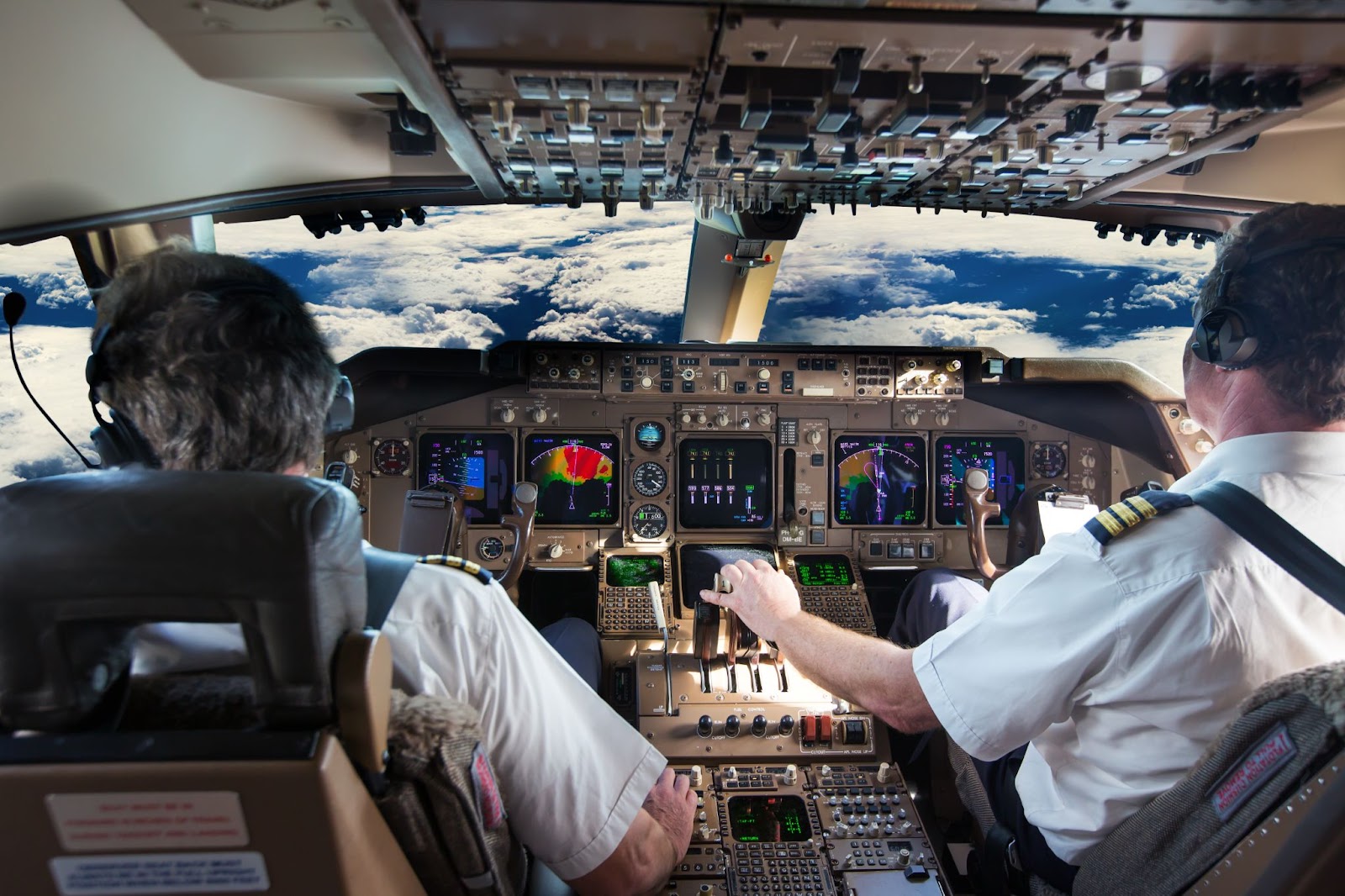 pilots inside a cabin of a modern aircraft 