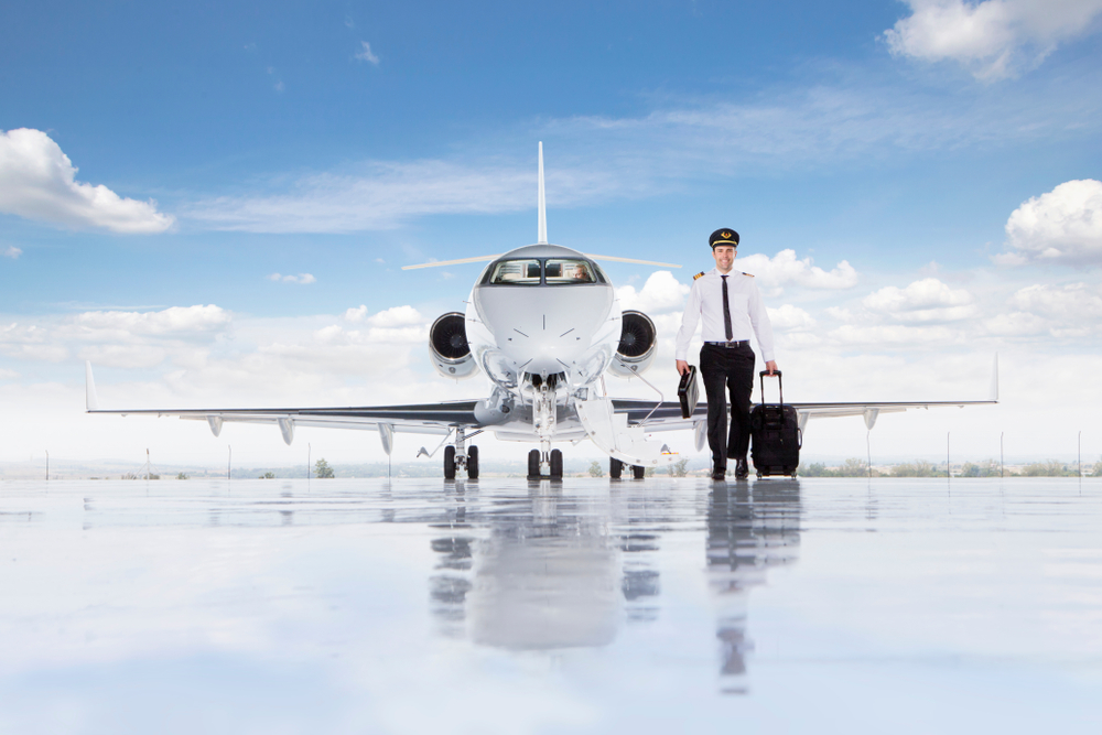 corporate pilot walking away from private jet